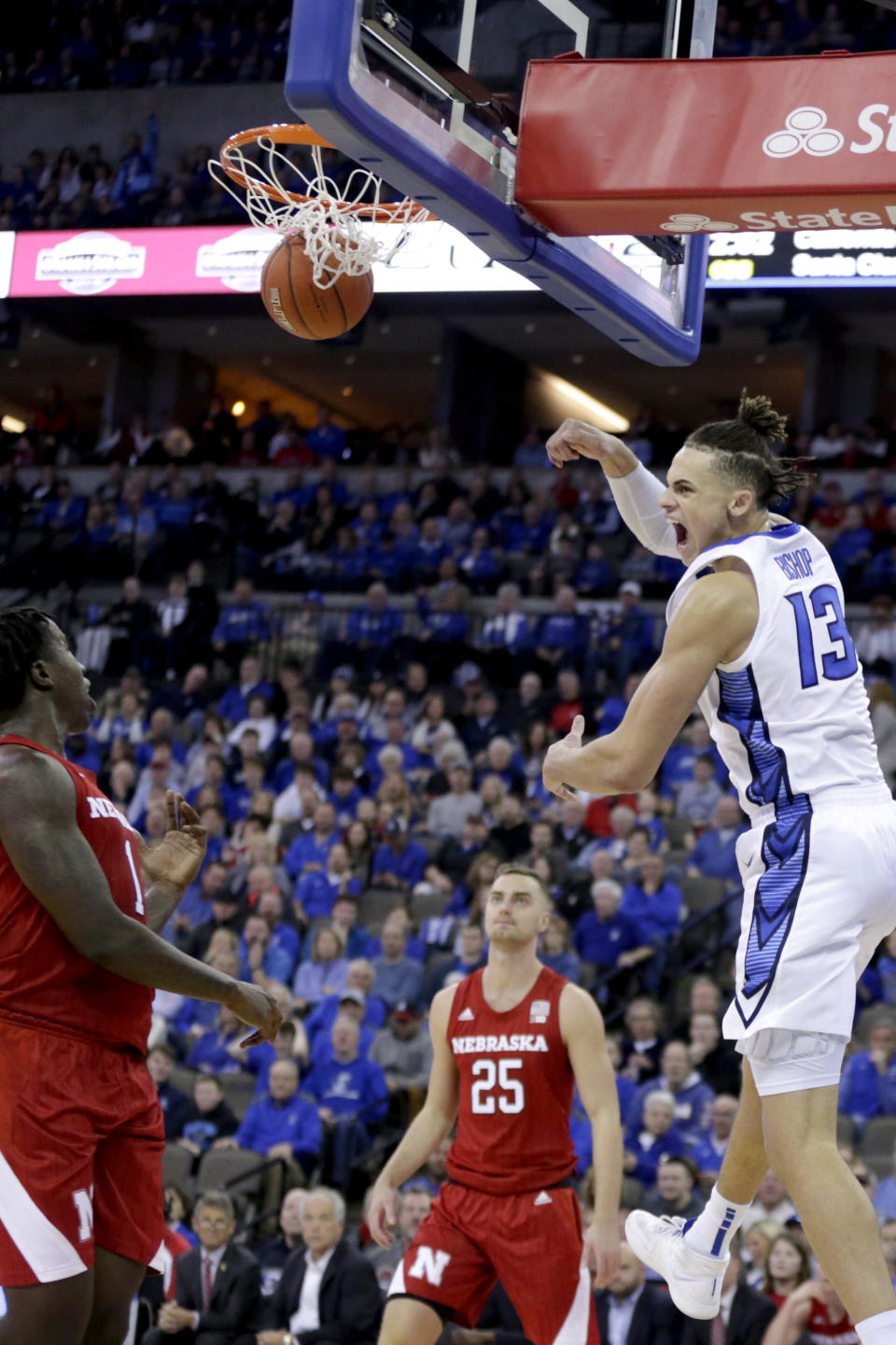 Creighton's Christian Bishop (13) dunks against Nebraska's Kevin Cross, left, and Matej Kavas (25) during the first half of an NCAA college basketball game in Omaha, Neb., Saturday, Dec. 7, 2019. (AP Photo/Nati Harnik)