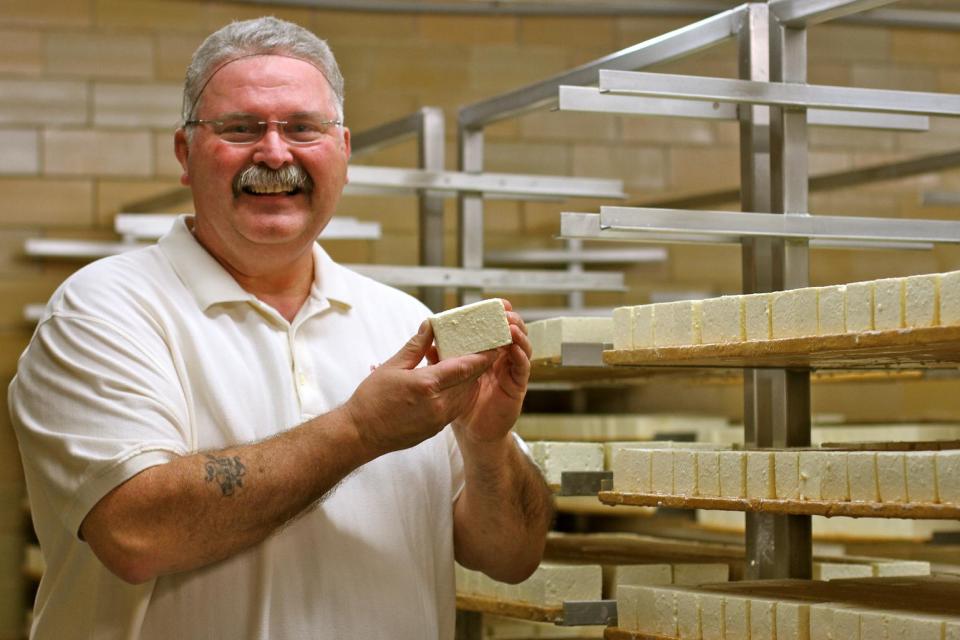 This April 19, 2013 photo shows master cheesemaker Myron Olson posing for a photo at the Chalet Cheese Cooperative in Monroe, Wis. The Cooperative is the only place in the United States where the famous "stinky cheese" is still produced. (AP Photo/Niamh O'Neill-Culhane)