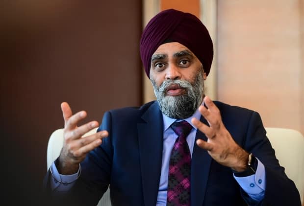 Amid a political firestorm over his own handling of the sexual misconduct crisis and calls for his resignation, Defence Minister Harjit Sajjan said he 'has the utmost confidence in acting chief of defence staff Lt.-Gen. Wayne Eyre over his decision to give the head of the navy a second chance.   (Sean Kilpatrick/The Canadian Press - image credit)