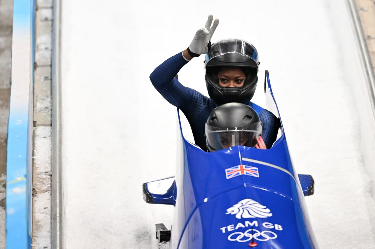 Mica Mcneill and Montell Douglas react after the final run in the 2-woman bobsleigh event during the Beijing 2022 Winter Olympic Games