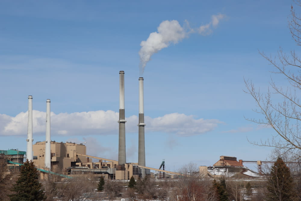 Steam rises from the Colstrip Steam Electric Station's Unit 4. Beside it is Unit 3, which was temporarily shut down for maintenance, while Units 1 and 2 (left) were permanently shut down in 2020. (Photo: Kelsey Turner) 