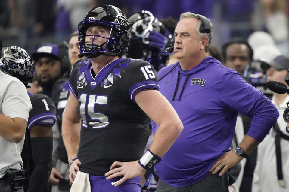 TCU quarterback Max Duggan (15) and head coach Sonny Dykes, right, watch in the first half of the Big 12 Conference championship NCAA college football game against Kansas State, Saturday, Dec. 3, 2022, in Arlington, Texas. (AP Photo/LM Otero)