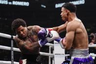 Rolando Romero, right, punches Gervonta Davis during the first round of a WBA lightweight championship boxing bout early Sunday, May 29, 2022, in New York. Davis won in the sixth round. (AP Photo/Frank Franklin II)