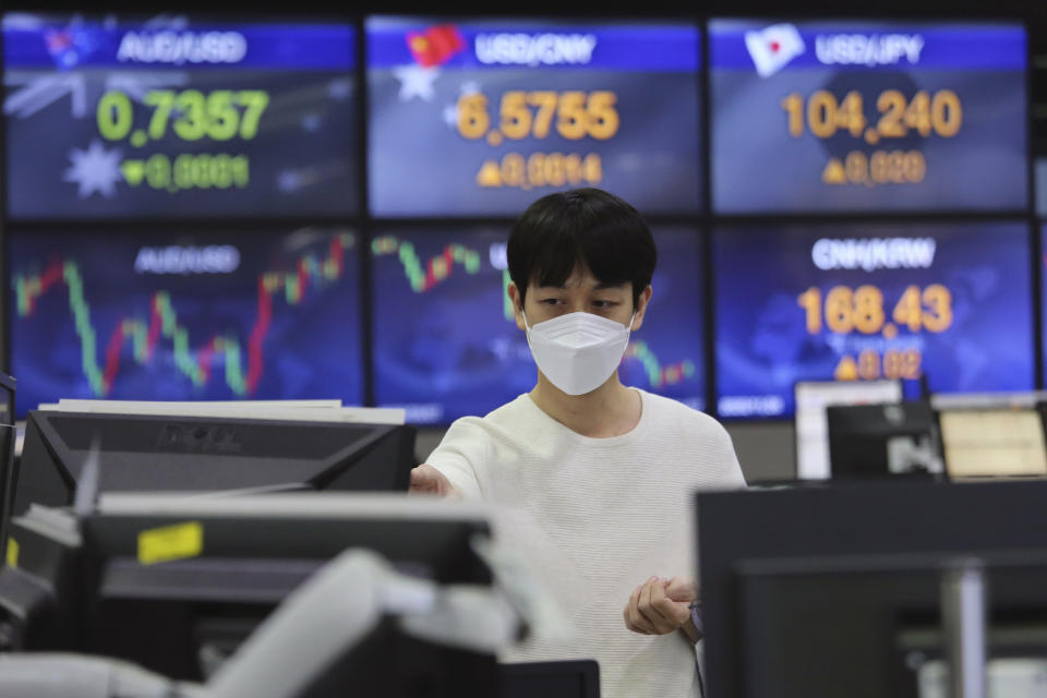 A currency trader watches monitors at the foreign exchange dealing room of the KEB Hana Bank headquarters in Seoul, South Korea, Friday, Nov. 27, 2020. Asian stock markets declined Friday as questions about the effectiveness of one possible coronavirus vaccine weighed on investor optimism. (AP Photo/Ahn Young-joon)