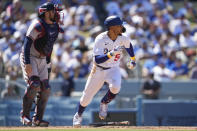 Los Angeles Dodgers' Mookie Betts (50) singles during the fifth inning of a baseball game against the Atlanta Braves in Los Angeles, Sunday, Sept. 3, 2023. Miguel Rojas scored. (AP Photo/Ashley Landis)