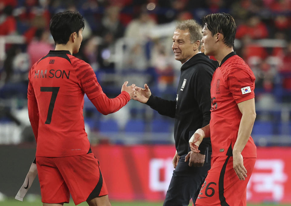 South Korea's head coach Jurgen Klinsmann, second from right, encourages South Korea's Son Heung-min, left, as South Korea's Oh Hyeon-gyu, right, walks after their friendly soccer match between South Korea and Colombia in Ulsan, South Korea, Friday, March 24, 2023. (Shin Hyun-woo/Yonhap via AP)