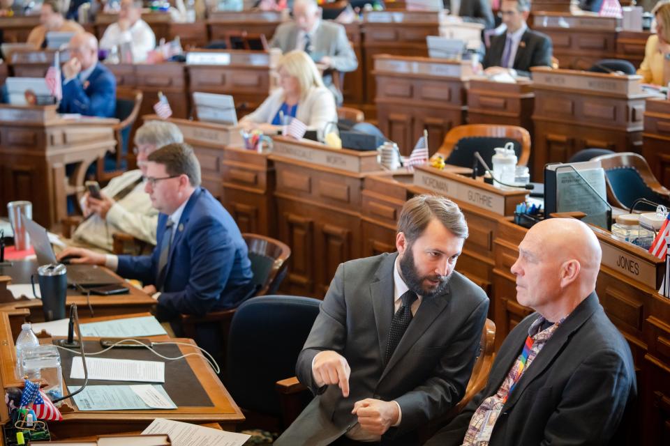 State Rep. Bobby Kaufmann, R-Wilton, speaks with state Rep. Dave Jacoby, D-Coralville, on the House floor at the Iowa State Capitol, Monday, May 1, 2023.