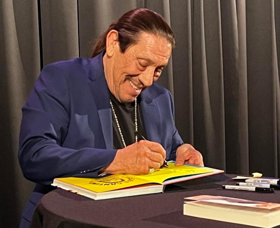 Danny Trejo signs a book during a meet and greet with fans following his appearance Thursday at Canton Palace Theatre as part of a joint presentation by Kent State University at Stark and Stark Library.