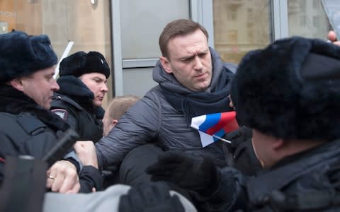 Police arrest opposition leader Alexei Navalny on Sunday at the Moscow rally for an election boycott - Credit: Evgeny Feldman/AP Photo