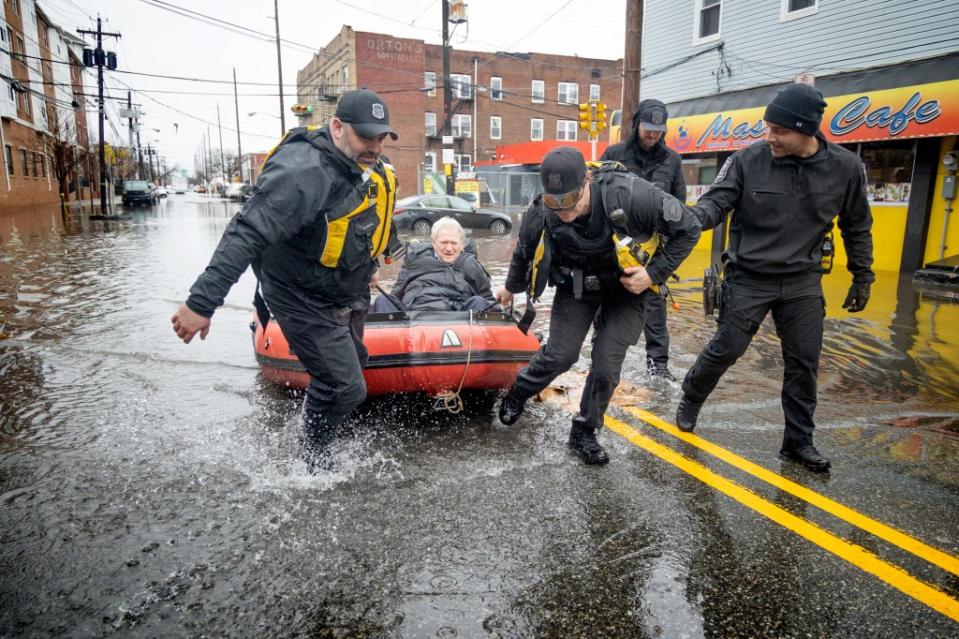 Across the river in Newark, Doctor Mark Pollack was seen being pulled on a red raft by a Newark Police Emergency Services member after he was stranded in the flooding zone. Aristide Economopoulos