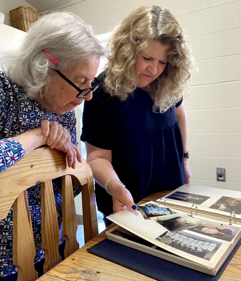 Marge Long and her daughter, the Rev. Leslie Long, look at church photo albums after the Clark Memorial United Methodist Church deconsecration service in Oklahoma City.