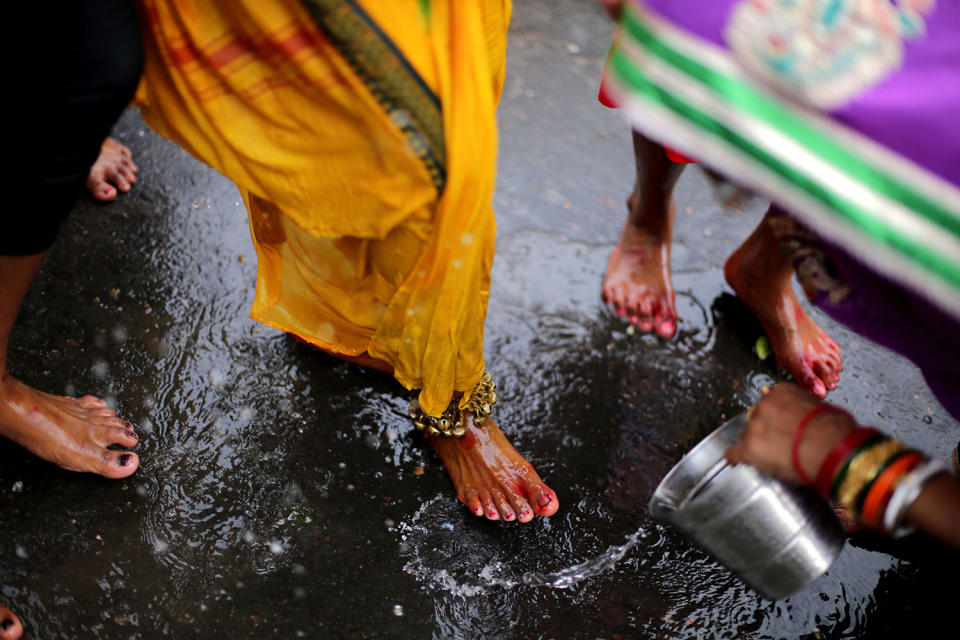 Hindu devotees with their bodies pierced take part in a religious procession.