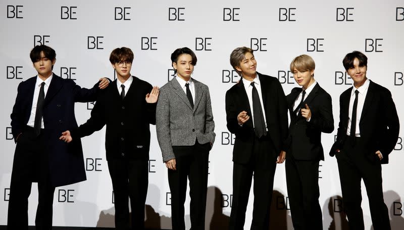 FILE PHOTO: Members of K-pop boy band BTS pose for photographs during a news conference promoting their new album "BE(Deluxe Edition)" in Seoul