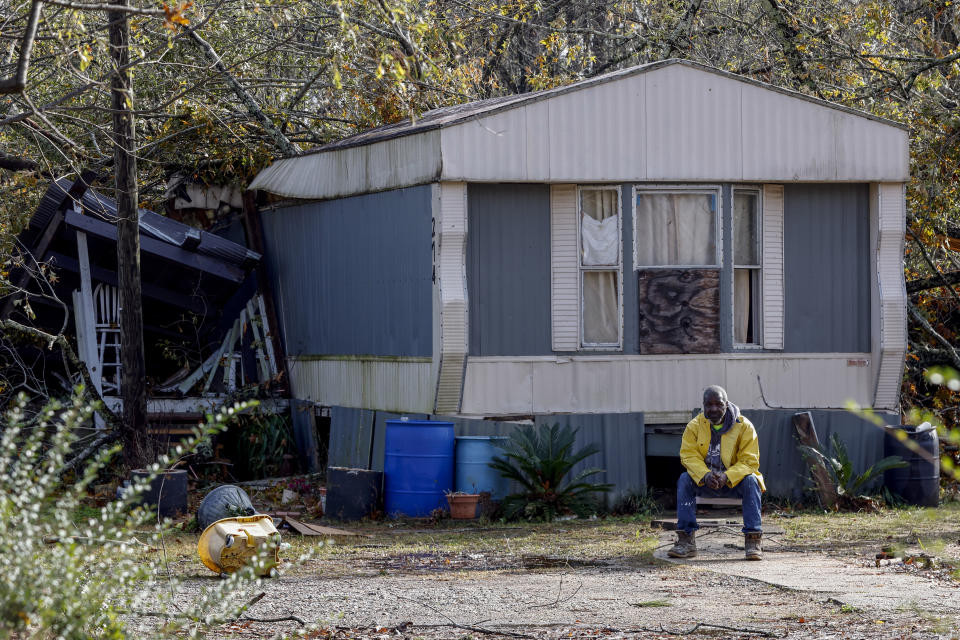 Jefferey Jordan sits in front of his damaged home, Wednesday, Nov. 30, 2022, in Flatwood, Ala., following a severe storm. Two people were killed in the Flatwood community just north of the city of Montgomery. (AP Photo/Butch Dill)