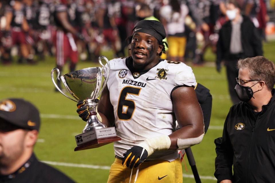 Missouri defensive lineman Darius Robinson (6) carries the Mayor's Cup after an NCAA college football game against South Carolina, Saturday, Nov. 21, 2020, in Columbia, S.C.