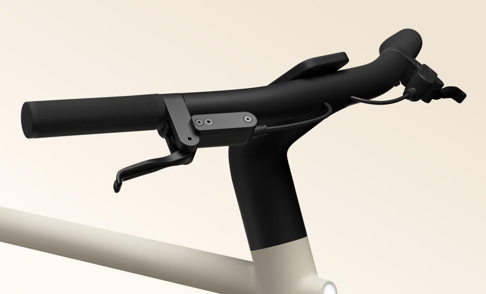 Front-side view of the Cowboy Cruiser e-bike handlebars. A phone is mounted in the center.