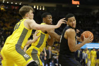 Butler's Bryce Nze, right, drives to the basket against Marquette defenders during the second half of an NCAA college basketball game Sunday, Feb. 9, 2020, in Milwaukee. (AP Photo/Aaron Gash)