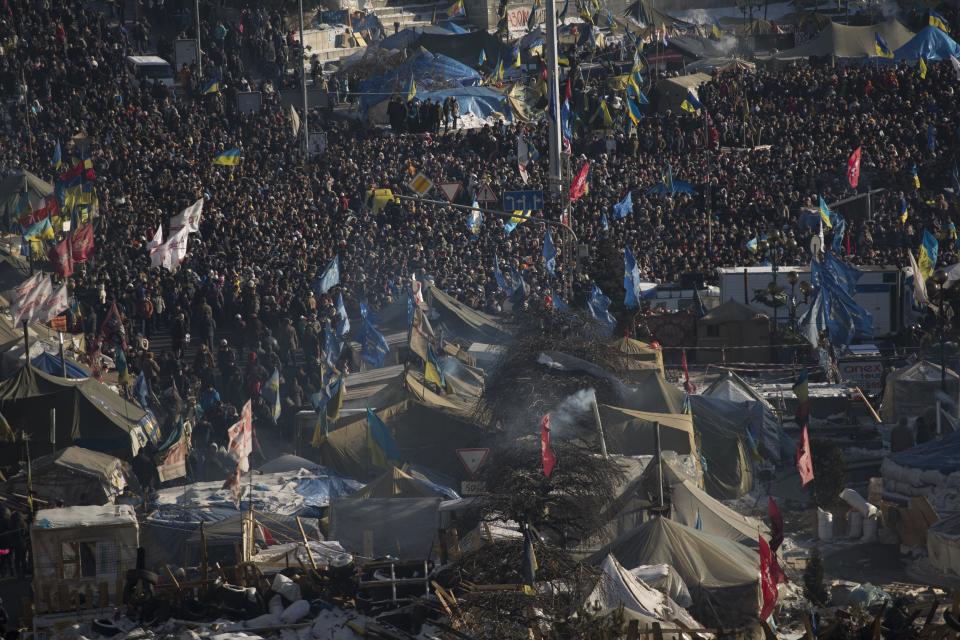 Anti-government protesters take part in a rally in central Kiev, Ukraine, Sunday, Feb. 2, 2014. Protesters seeking Yanukovych's resignation held one of their largest gatherings in recent weeks on Sunday, with about 30,000 people assembling at the main protest site in Kiev's central square. (AP Photo/Emilio Morenatti)