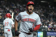 Cincinnati Reds' Jeimer Candelario shouts as he celebrates his run scored against the Arizona Diamondbacks during the eighth inning of a baseball game Monday, May 13, 2024, in Phoenix. (AP Photo/Ross D. Franklin)