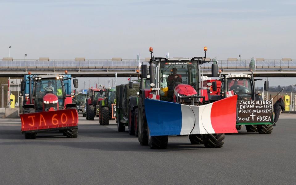 Farmers drive their tractors near Chamant on a highway leading to Paris, Jan 29