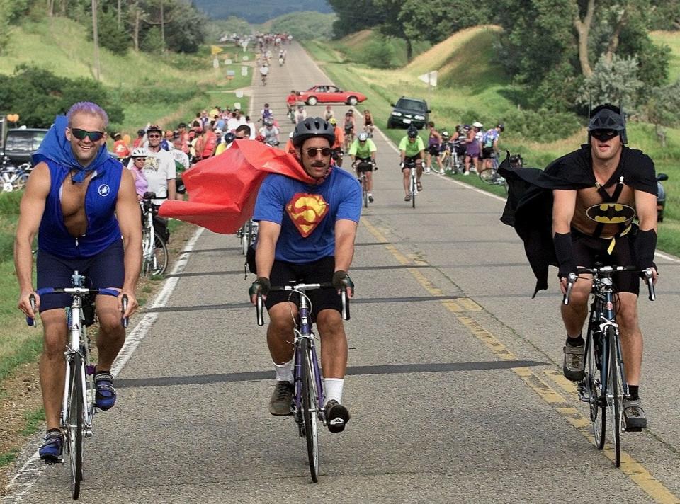 Team Justice League members Mr. Freeze, left, Derek Brigham of Minneapolis; Superman Peter Metzig, center, of Waupaca Wisconsin; and Dave Clark of Minneapolis as Batman, ride out of Sioux City on July 22, 2001.