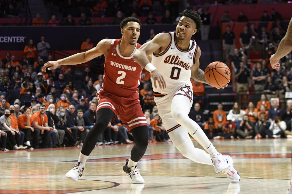 Illinois' Terrence Shannon Jr. (0) works the ball against Wisconsin's Jordan Davis (2) during the first half of an NCAA college basketball game, Saturday, Jan. 7, 2023, in Champaign, Ill. (AP Photo/Michael Allio)