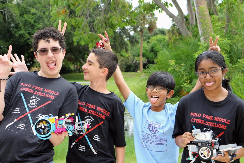 From left to right: Maxx Swisher,13, Ethan Aronson, 12, Daanish Kazi, 11, and Lucky Vishnuvardhan, 12, pose with Lego robots outside of the Cox Science Center on Saturday, Sept. 17, 2022.