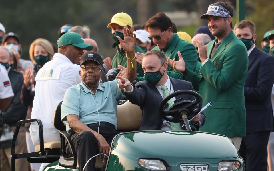 Honorary starting golfer Lee Elder (C-L) is ferried via cart to the first tee to start the first round of the 2021 Masters Tournament at the Augusta National Golf Club in Augusta, Georgia, USA, 06 April 2021 - SHUTTERSTOCK