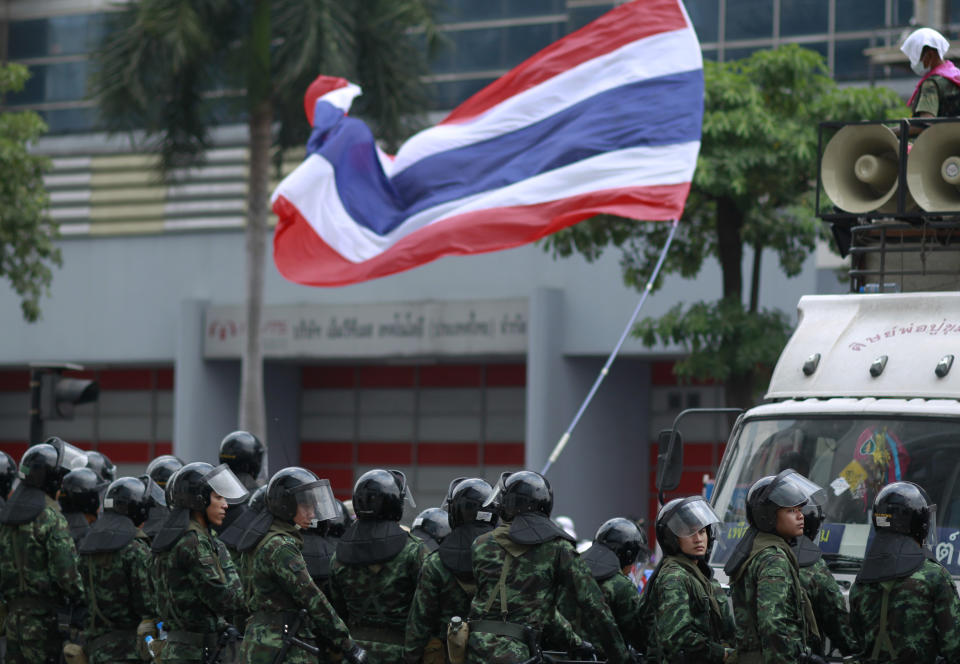 Soldiers stand guard outside the Permanent Secretary of Defense building during an anti-government protest on the outskirts of Bangkok, Thailand, Wednesday, Feb. 19, 2014. Anti-government protesters surrounded Prime Minister Yingluck Shinawatra's temporary office to demand her resignation a day after clashes. (AP Photo/Wally Santana)