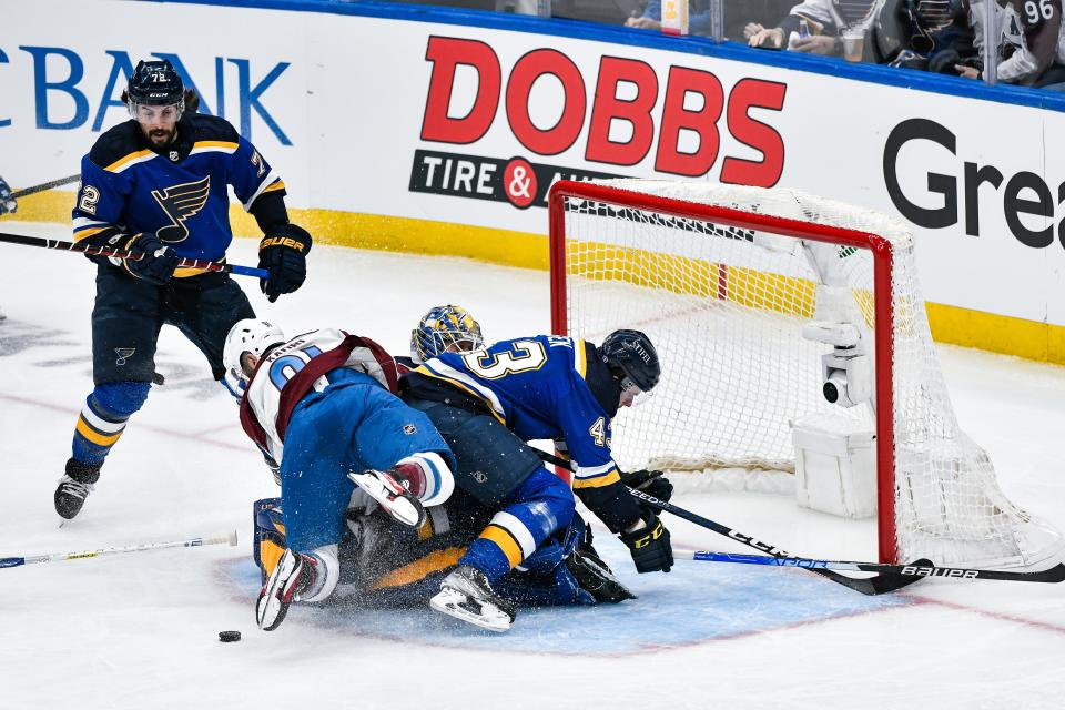 ST. LOUIS, MO - MAY 21: Colorado Avalanche center Nazem Kadri (91) and St. Louis Blues defenseman Calle Rosen (43) fall on St. Louis Blues goaltender Jordan Binnington (50) injuring him causing him to leave the game during Round 2 game 3 of the Stanley Cup Playoffs between the Colorado Avalanche and the St. Louis Blues on May 21, 2022, at the Enterprise Center in St. Louis MO (Photo by Rick Ulreich/Icon Sportswire via Getty Images)