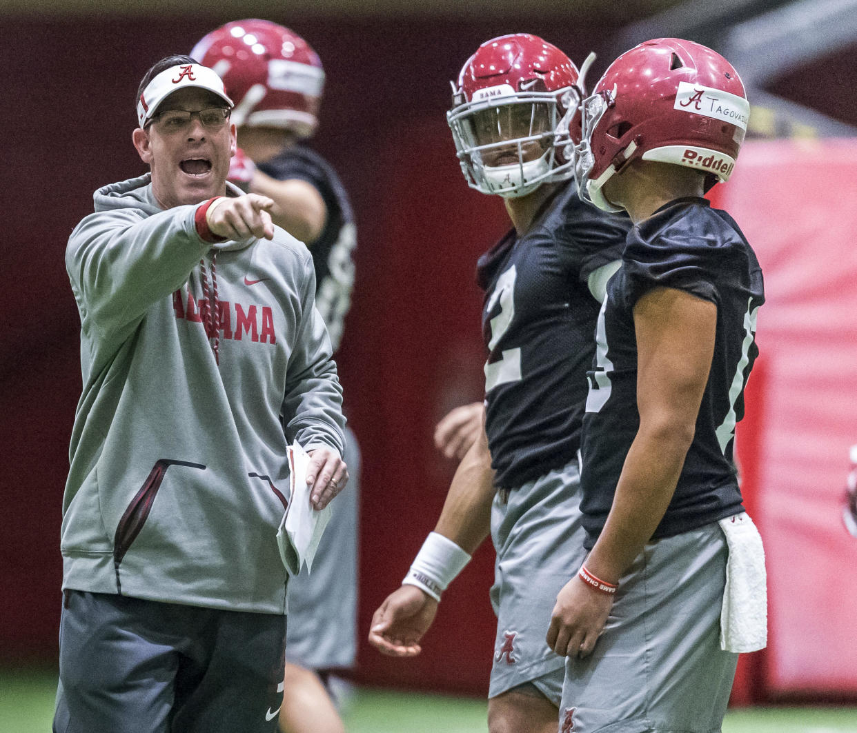 Alabama quarterbacks coach Dan Enos directs passing drills as quarterbacks Jalen Hurts (2) and Tua Tagovailoa (13) listen during the NCAA college football team’s spring practice Tuesday, March 20, 2018, in Tuscaloosa, Ala. (Vasha Hunt/AL.com via AP)