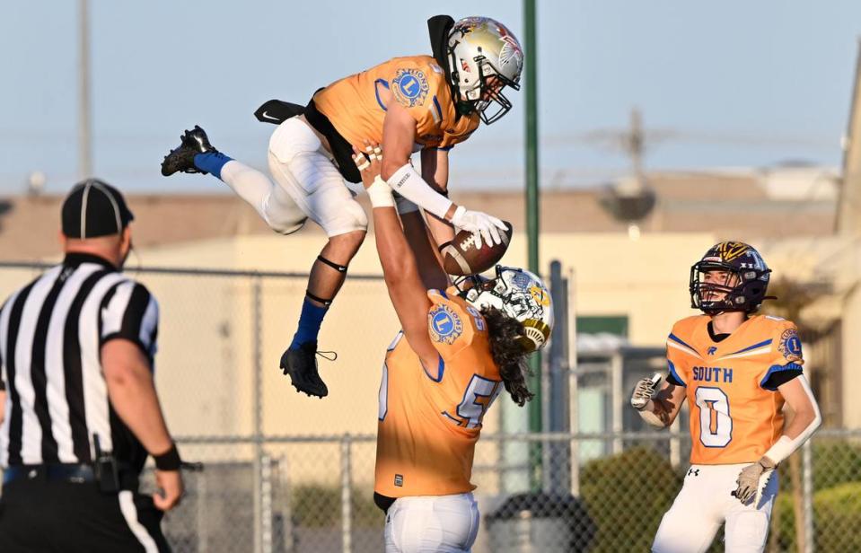 South’s Fermin Villegas lifts up teammate Joey Stout (3) to celebrate a touchdown during the Central California Lions All-Star Football Game at Tracy High School in Tracy, Calif., Saturday, June 24, 2023. The South won the game 38-13. Andy Alfaro/aalfaro@modbee.com