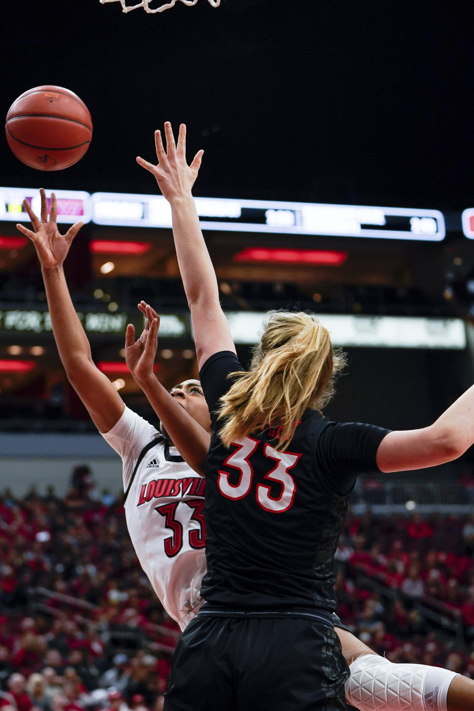 Louisville forward Bionca Dunham (33) shoots the ball over Virginia Tech center Elizabeth Kitley (33) during the first half of a women's NCAA college basketball game, Sunday, March 1, 2020, at the KFC YUM Center in Louisville, Ky. (AP Photo/Bryan Woolston)