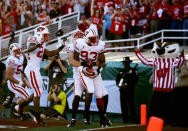 PASADENA, CA - JANUARY 02: Defensive lineman Louis Nzegwu #93 of the Wisconsin Badgers returns a fumble by Darron Thomas #5 of the Oregon Ducks for a 33-yards and a touchdown in the second quarter at the 98th Rose Bowl Game on January 2, 2012 in Pasadena, California. (Photo by Jeff Gross/Getty Images)