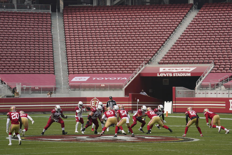 Empty seats at Levi's Stadium are shown as Arizona Cardinals quarterback Kyler Murray (1) takes the snap against the San Francisco 49ers during the second half of an NFL football game in Santa Clara, Calif., Sunday, Sept. 13, 2020. (AP Photo/Tony Avelar)