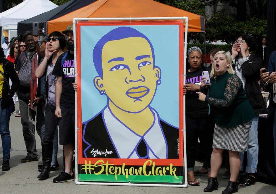 FILE - In this April 9, 2018 file photo protesters display an image of Stephon Clark at a crime victims rights rally, at the Capitol in Sacramento, Calif. Two Sacramento police officers won't face criminal charges for the fatal shooting of Clark following a chase that ended in his grandparents' yard and started a series of angry protests that roiled California's capital city, the county's top prosecutor announced Saturday, March 2, 2019, following a nearly yearlong investigation. (AP Photo/Rich Pedroncelli,File)