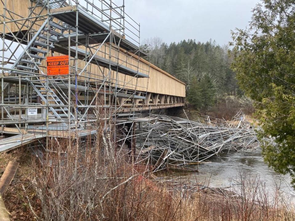 Water pressure from an overnight rainfall caused scaffolding surrounding the Smithtown Covered Bridge to collapse Thursday.  (Aniekan Etuhube/CBC - image credit)