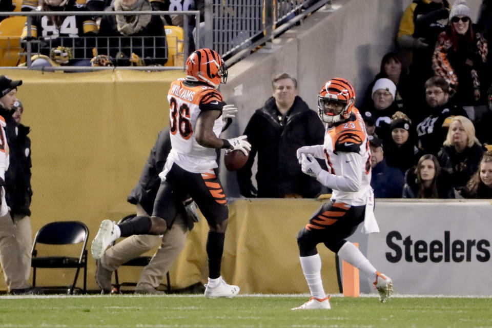 Cincinnati Bengals strong safety Shawn Williams (36) takes an interception of a pass by Pittsburgh Steelers quarterback Ben Roethlisberger (7) to the end zone for a touchdown as cornerback Darius Phillips (23) watches in the second quarter of an NFL football game Sunday, Dec. 30, 2018, in Pittsburgh. (AP Photo/Gene J. Puskar)