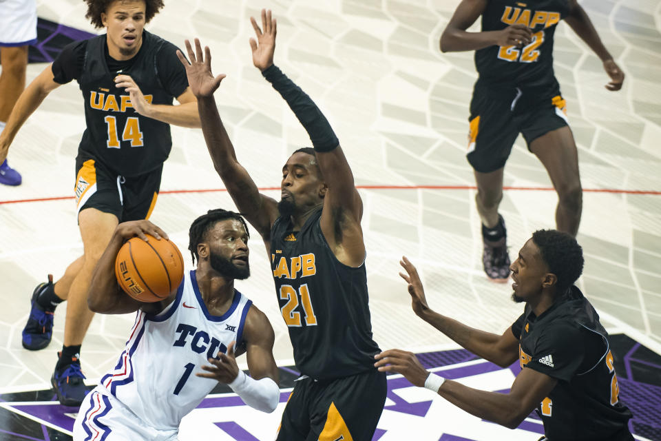 TCU guard Mike Miles Jr. (1) attempts to get around Arkansas-Pine Bluff guard Shaun Doss Jr. (21) in the first half of an NCAA college basketball game in Fort Worth, Texas, Monday, Nov. 7, 2022. (AP Photo/Emil Lippe)