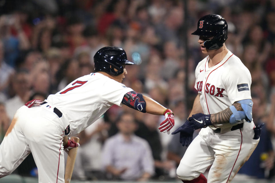 Boston Red Sox's Tyler O'Neill, right, is congratulated by Masataka Yoshida after his two-run home run against the Toronto Blue Jays during the sixth inning of a baseball game at Fenway Park, Tuesday, June 25, 2024, in Boston. (AP Photo/Charles Krupa)