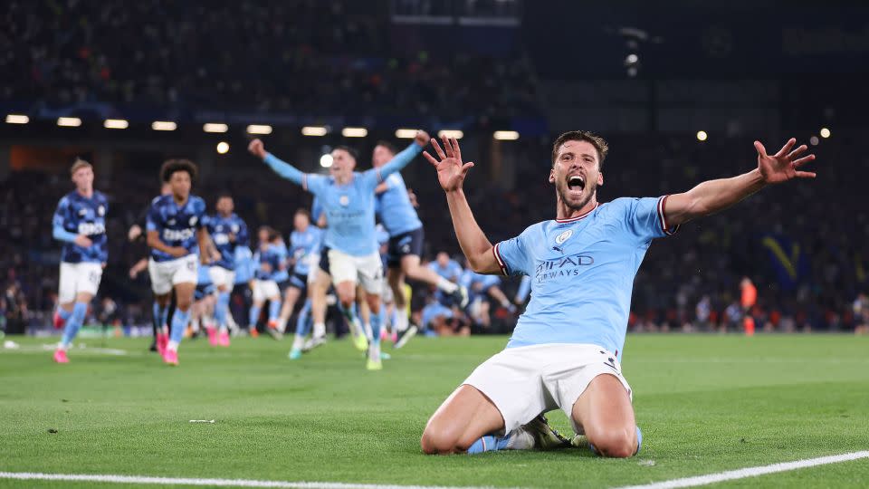 Rúben Dias and the Manchester City squad celebrate their historic treble. - Catherine Ivill/Getty Images