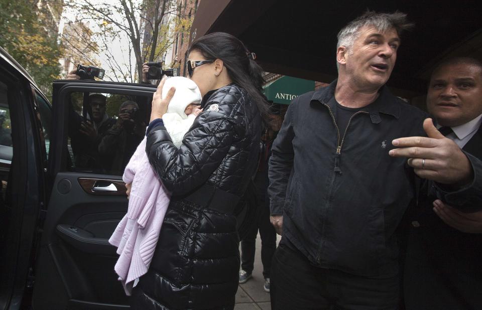 Alec Baldwin demands the media step away as his wife Hilaria Thomas carries daughter Carmen into an SUV outside his apartment in New York