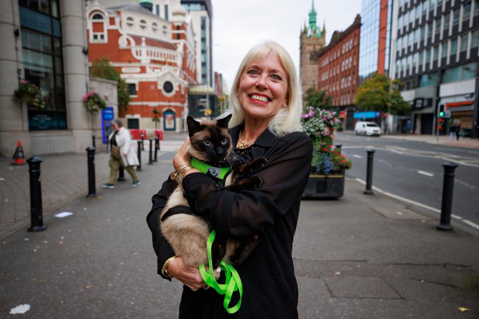 Holly Hennessy with her Siamese cat Captain at the Europa Hotel in Belfast, both of whom have been stuck in Belfast for the past four months amid delays to the departure of the Villa Vie Odyssey cruise ship Picture date: Saturday 28 September 2024 .