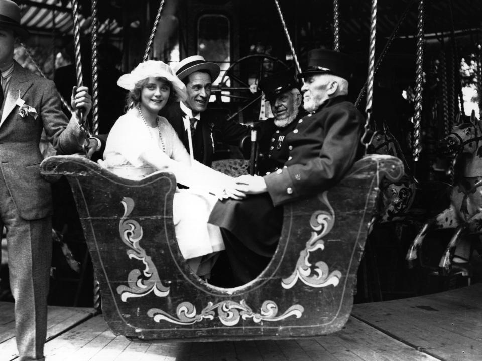 people enjoy a fair ride in 1920