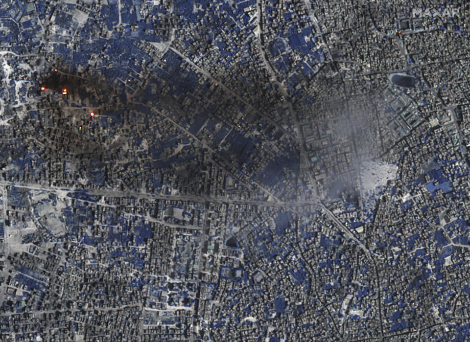 This image provided by Maxar Technologies shows a Shortwave Infrared (SWIR) close view of a number of burning buildings and active fires burning in Gaza City, Tuesday, Nov. 7, 2023. In SWIR satellite imagery, vegetation appears in shades of blue while active fires/thermal hot spots show up as an orange/yellow bloom. (Satellite image ©2023 Maxar Technologies via AP)