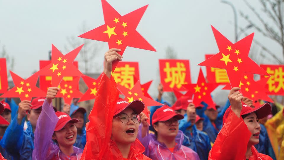 Attendees sing a patriotic song in Hangzhou, Zhejiang province on September 15, 2019 at an event marking the 70th anniversary of the founding of the People's Republic of China. - AFP/Getty Images