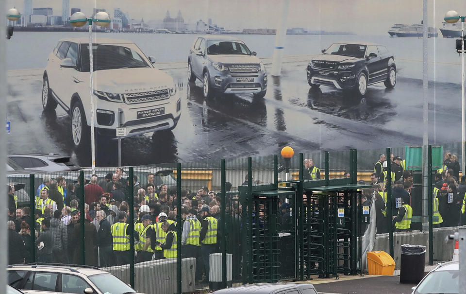 Staff gather inside the gates of the Jaguar Land Rover site in Halewood near Liverpool, England, Thursday Jan. 10, 2019. According to media reports, Jaguar Land Rover is widely expected to announce up to 5,000 job cuts as the carmaker addresses slowing demand in China and growing uncertainty about the U.K.'s Brexit departure from the European Union. (Peter Byrne/PA via AP)