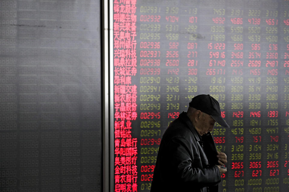 An investor prepares to leave a quiet brokerage house in Beijing, Wednesday, March 27, 2019. Shares were mixed in Asia early Wednesday after U.S. stocks finished broadly higher on Wall Street, erasing modest losses from a day earlier. (AP Photo/Andy Wong)