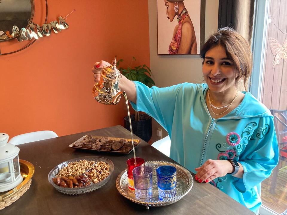 Asma El Idrissi pours sweet mint tea into Moroccan cups. Dates, nuts and pastries often accompany the hot drink. On Fridays she uses family recipes to cook Moroccan food for her family.