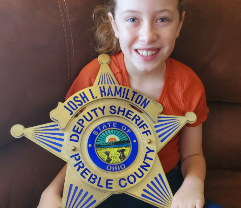 10-year-old Mikaelah Hamilton, with a Metal 4 Valor badge made in honor of her father, the late sheriff’s deputy Joshua Hamilton.